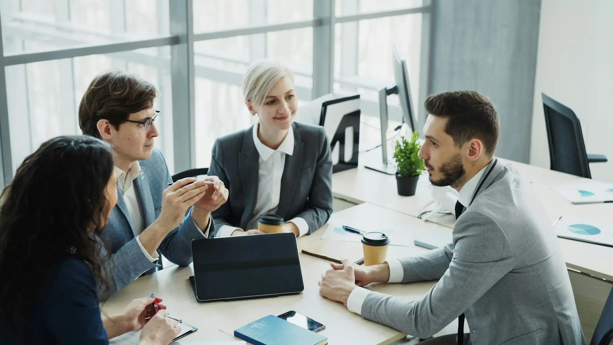 Business team talking through a decision in a modern office