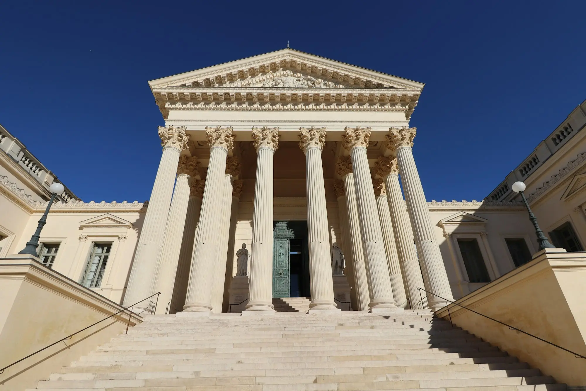 Large stone building with columns and a heavy front door